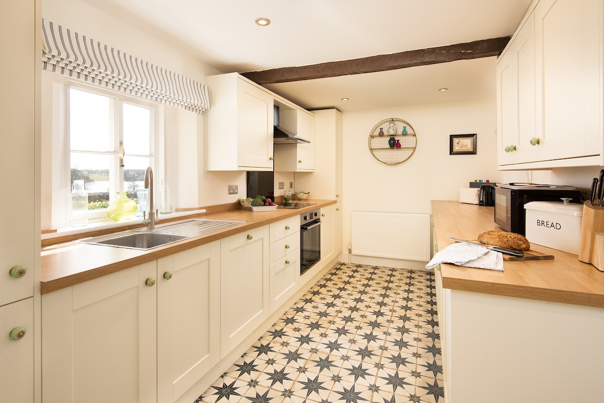 The School House, Capheaton - the kitchen with Victorian-inspired star tiled floor