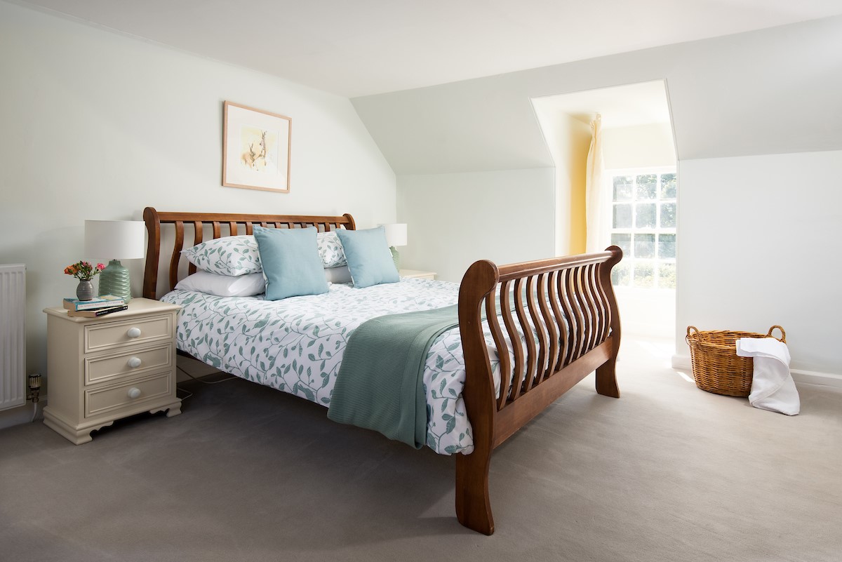 The White House - king size sleigh bed in bedroom two with garden views