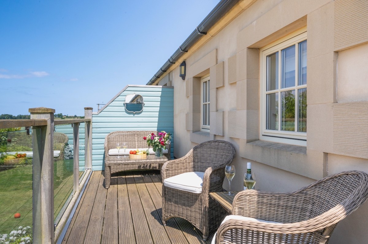 Skyfall - relax on the outdoor furniture situated on the balcony at the rear of the property