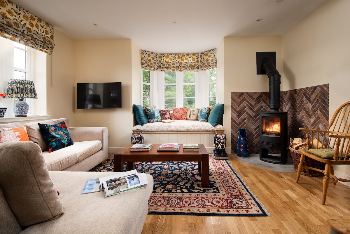 Rowchester West Lodge - open-plan livin space with ample seating and stylish wood burning stove