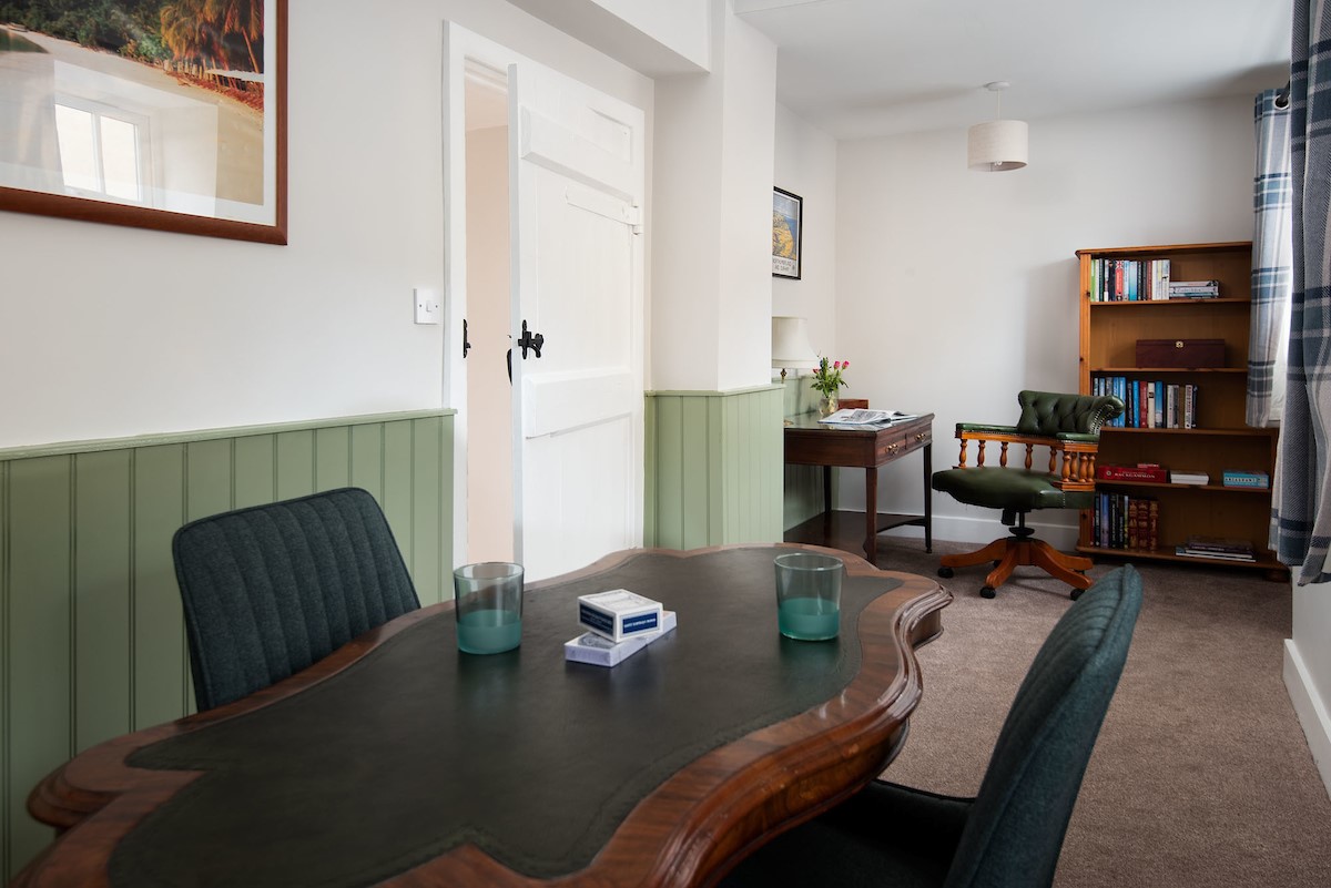 Grange House - office with desk and chair, a selection of books, and separate table that is ideal for playing card games
