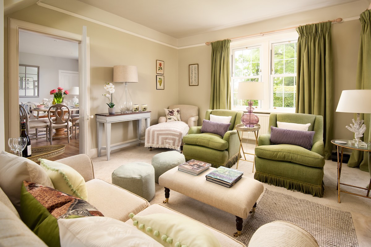 Lane Cottage - lounge area with a two-seater sofa, two armchairs, chaise and two pouffes