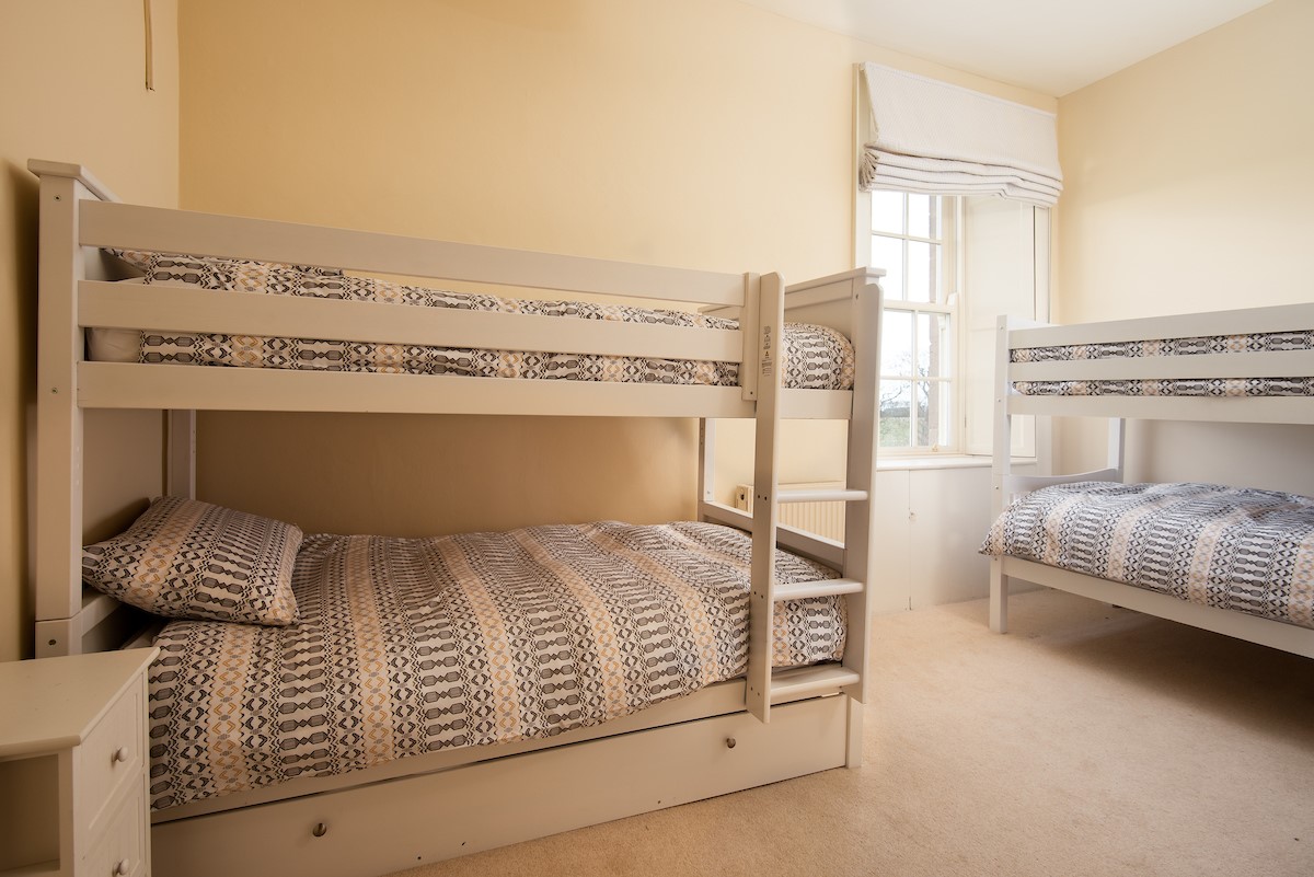 East House - bedroom five with two full size 3’ bunk beds sleeping four