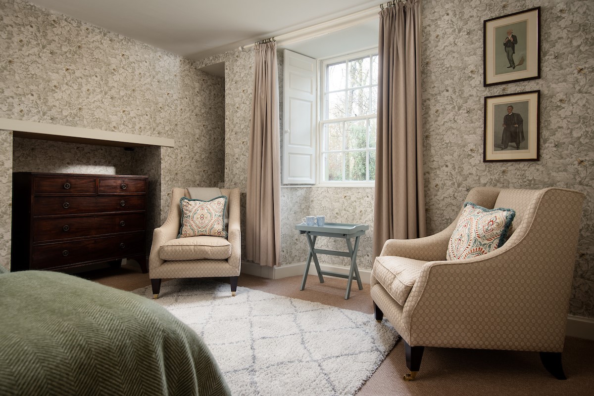 Cairnbank House - garden apartment bedroom two with two occasional chairs, wardrobe space and chest of drawers