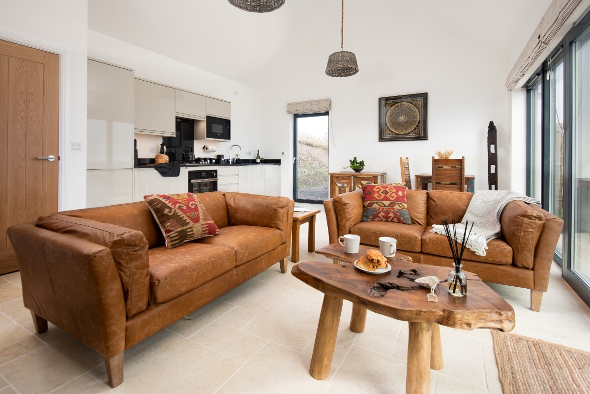 The Oak - open plan living room and kitchen with large bi-fold doors leading onto patio