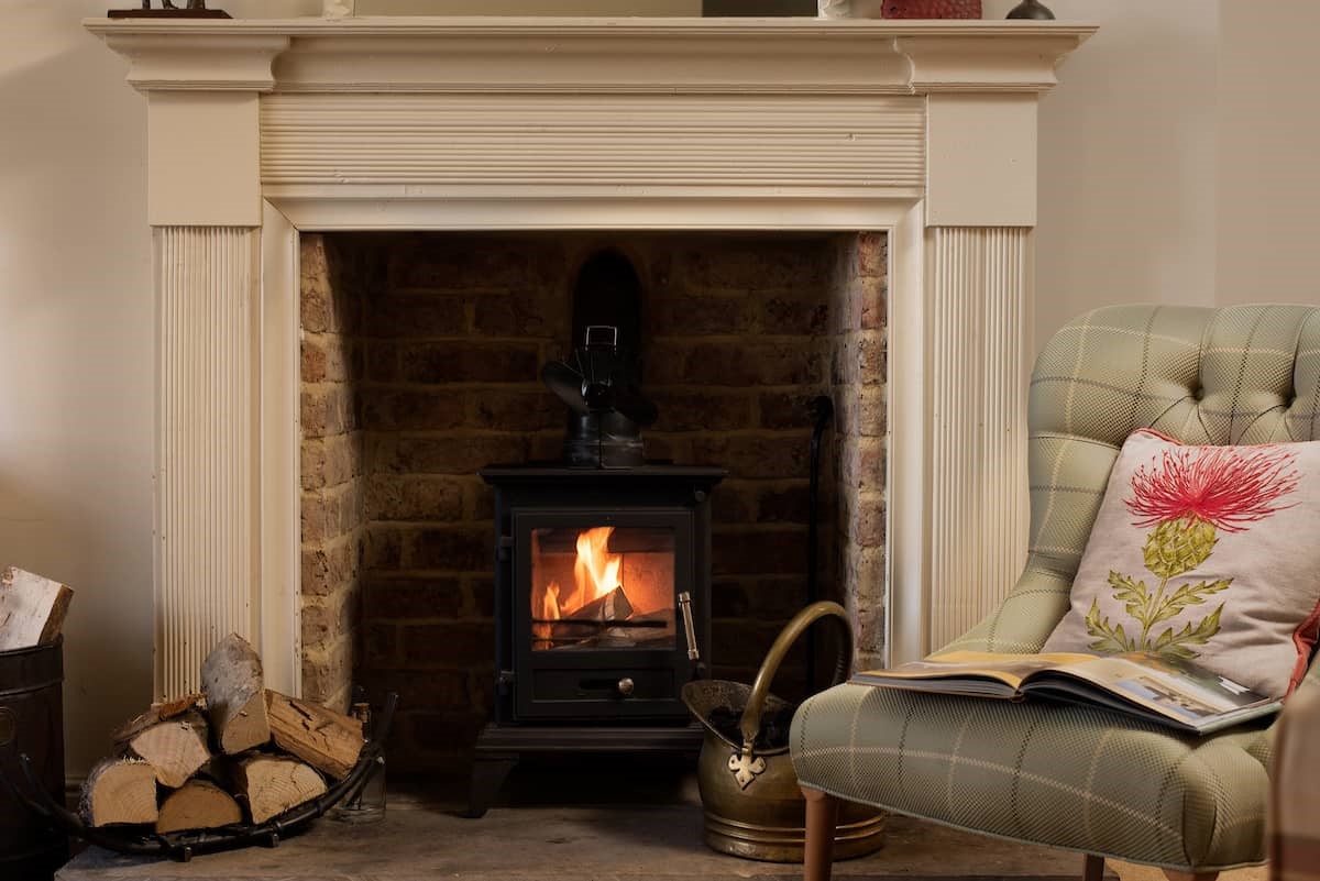 Anvil Cottage - the wood burning stove with fireside chair
