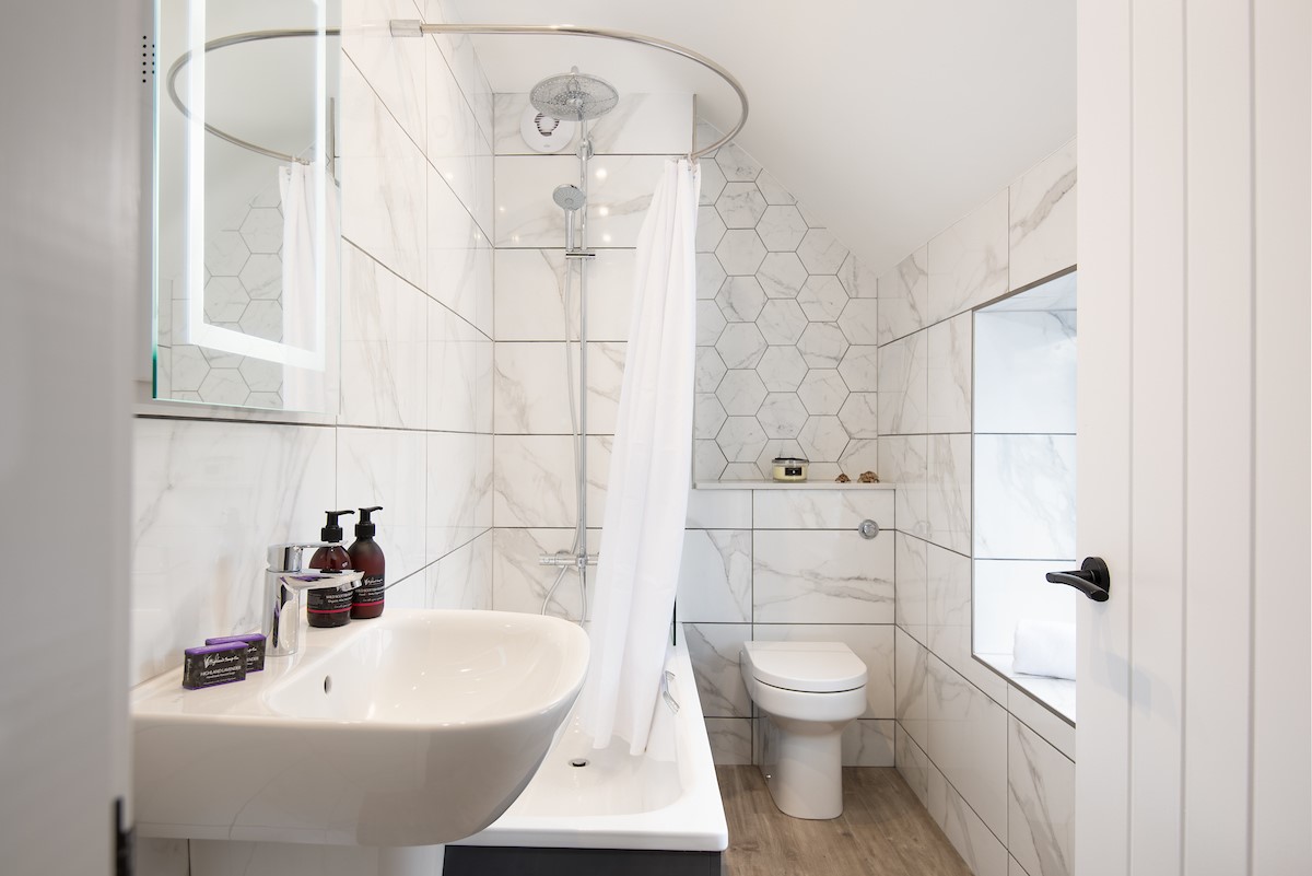 West Mill Cottage - the family bathroom features a bath with shower over