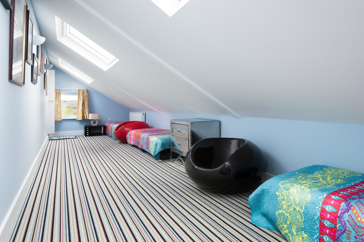 Fell End - Bedroom five is a quirky dorm room in the hallway to bedroom four, featuring two 60s pop chairs