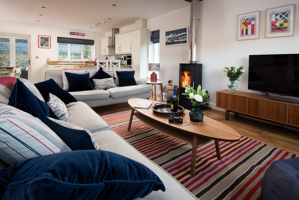 No. 6 - sitting room with two large three-seater sofas, coffee table, modern log burner and Smart TV
