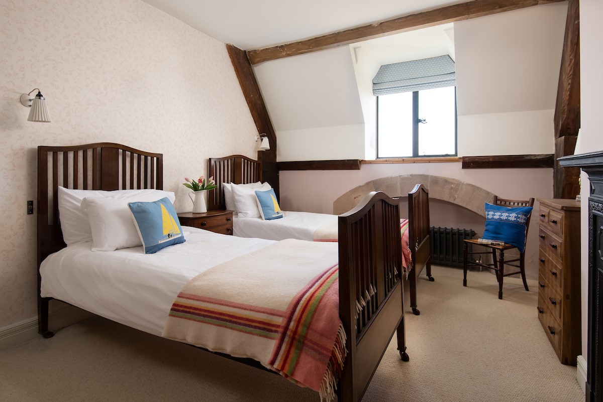 Lindisfarne View - bedroom two with twin beds and characterful wooden bedsteads