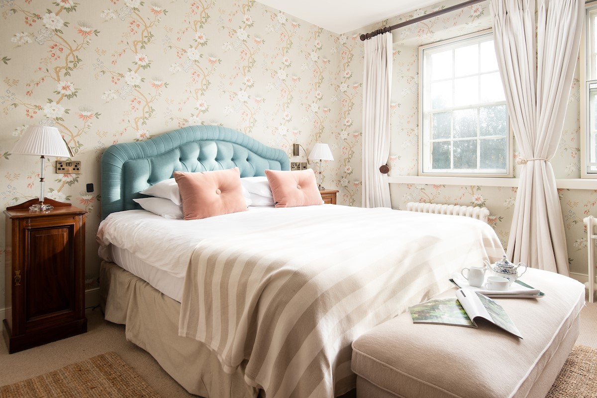 The Old Vicarage - bedroom three with double bed, bedside tables and ottoman storage bench