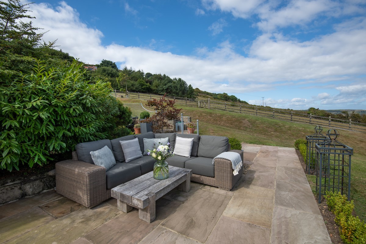 Bay View Cottage - the stone flagged patio with generous sofa seating