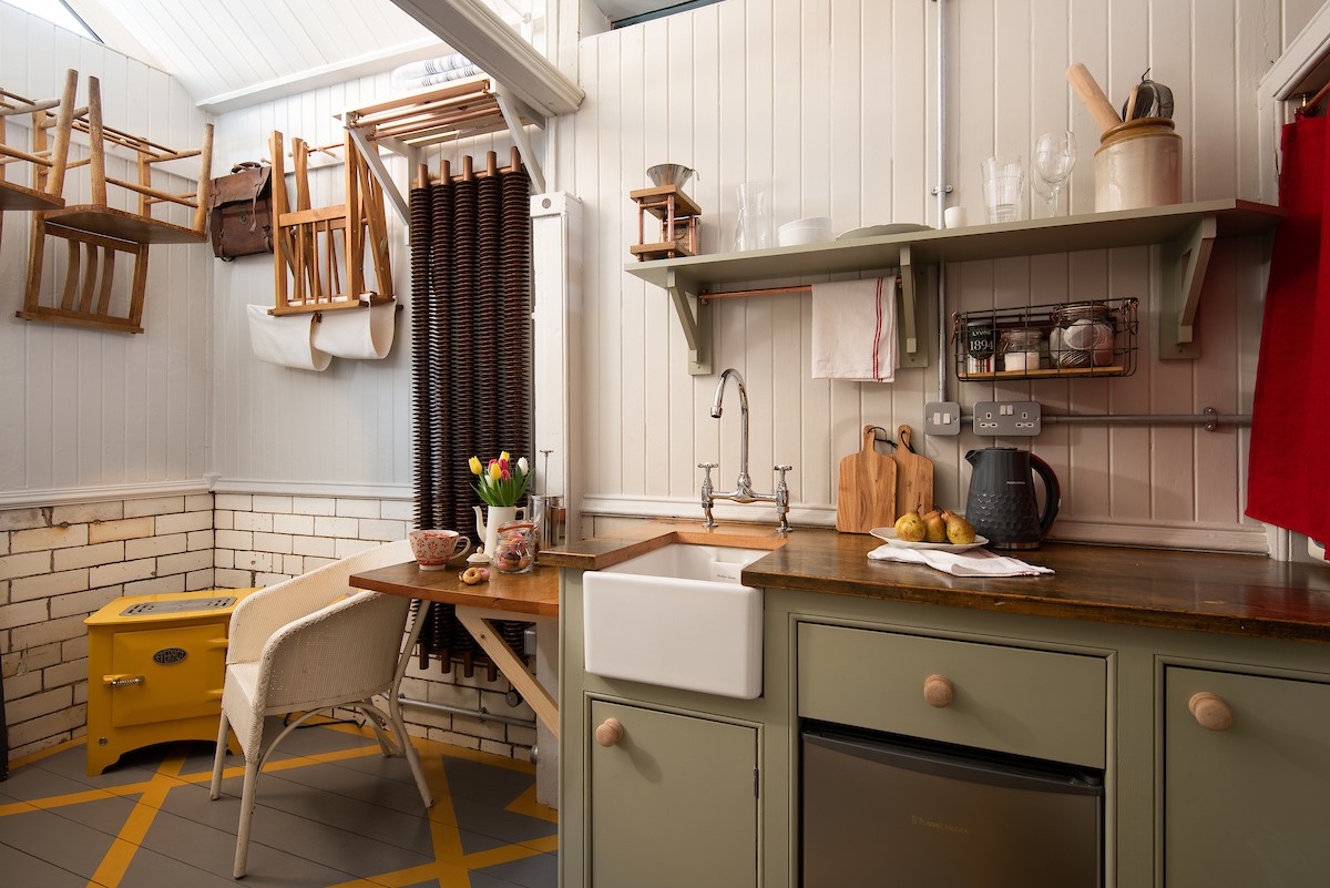 The Loovre - a hand-built kitchen complete with a reclaimed worktop and fold-down dining table for two