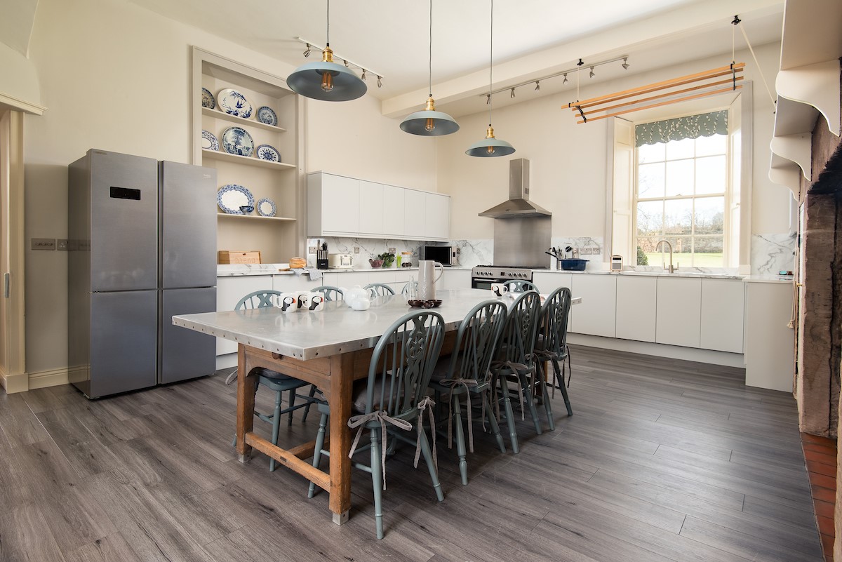 East House - the spacious kitchen with large American style fridge/freezer and informal dining space