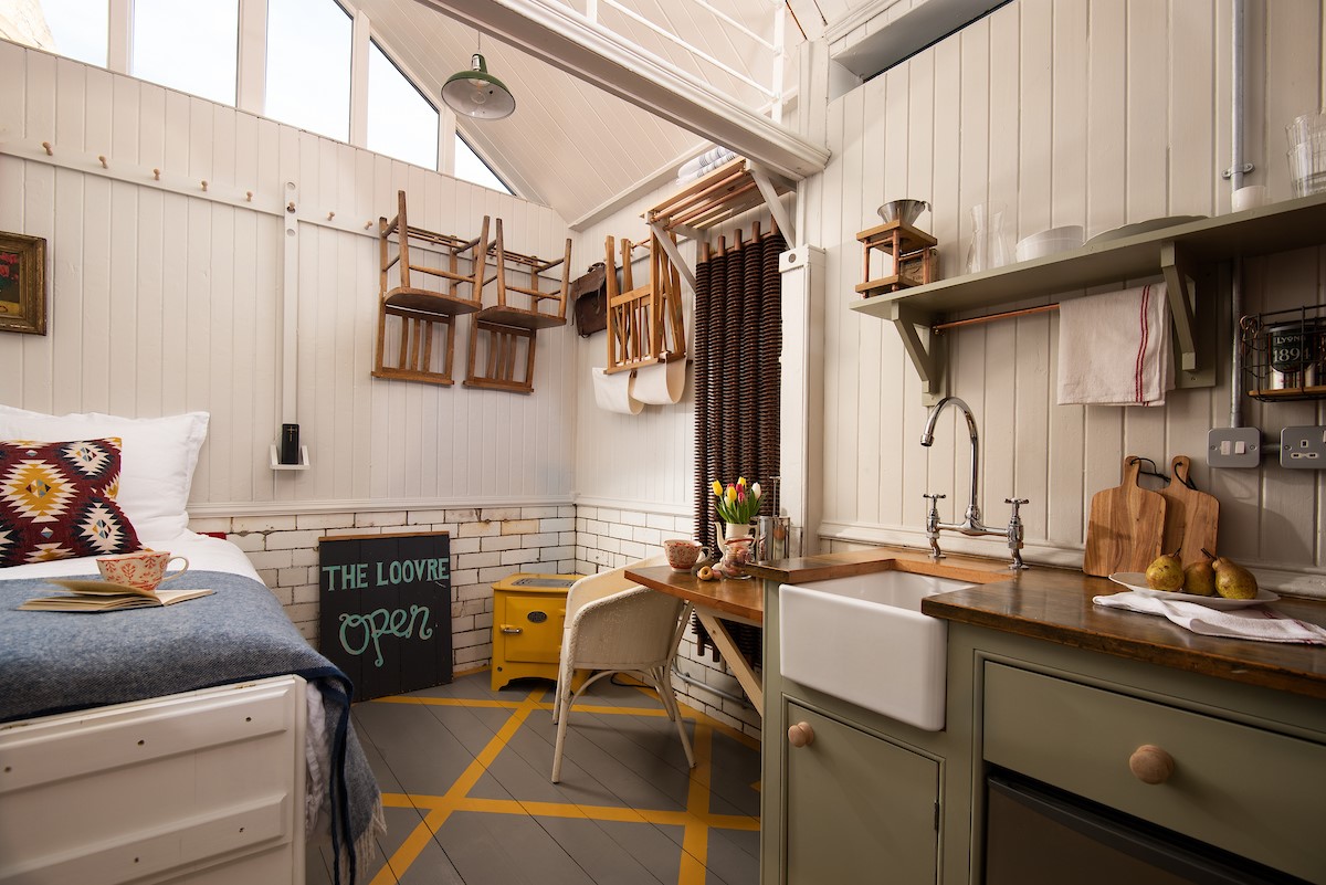 The Loovre - a shaker peg rail was custom made to maximise storage space in this tiny home