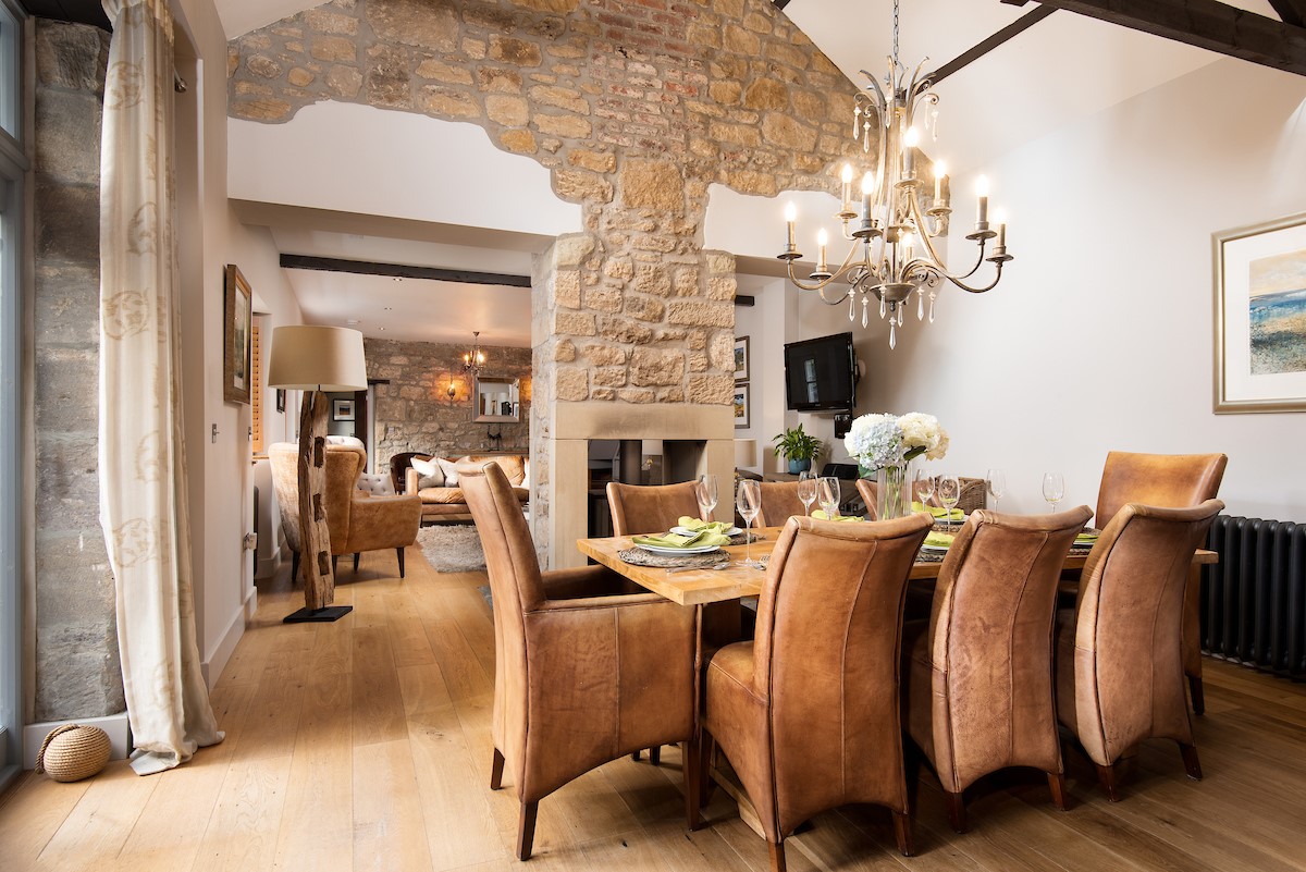 Coach House - open-plan living and dining areas share a double-sided wood burning stove
