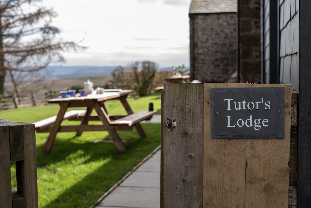 Tutor's Lodge - slate signage and picnic table within the rear garden