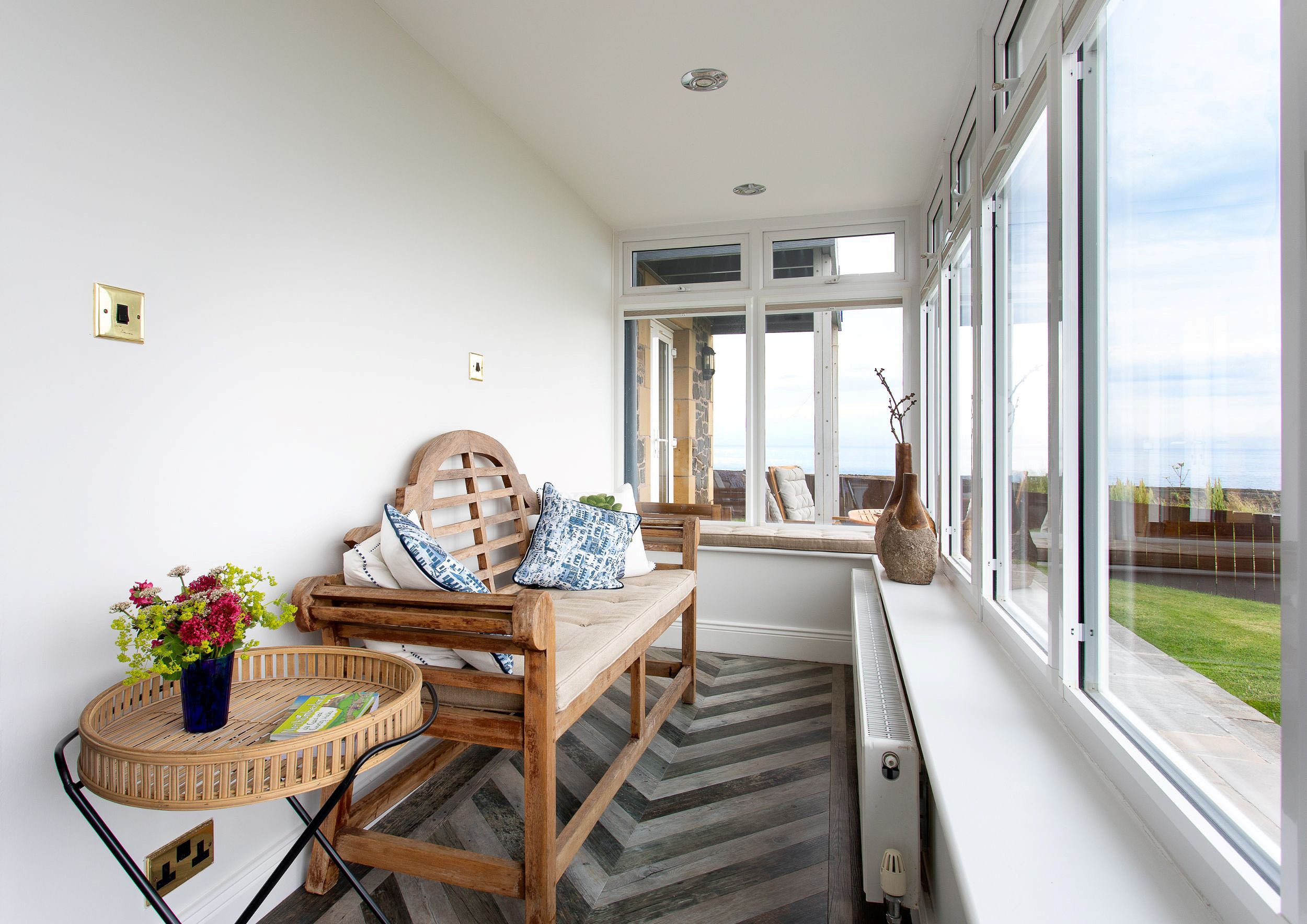 Sea Breeze - bench seating in the sun room where you can enjoy coastal views