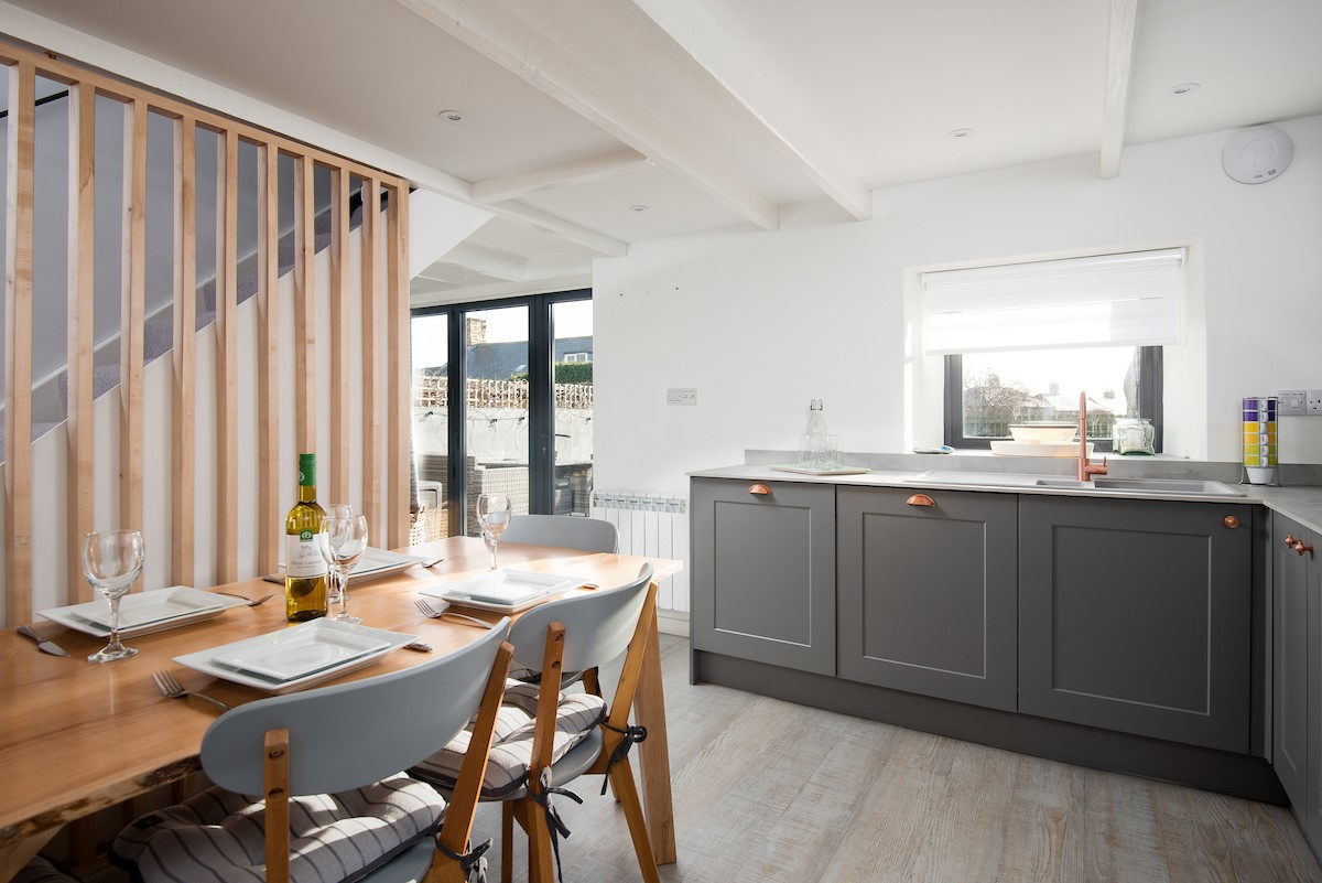 Red Herring - kitchen and dining area in the open-plan living space with sitting room beyond
