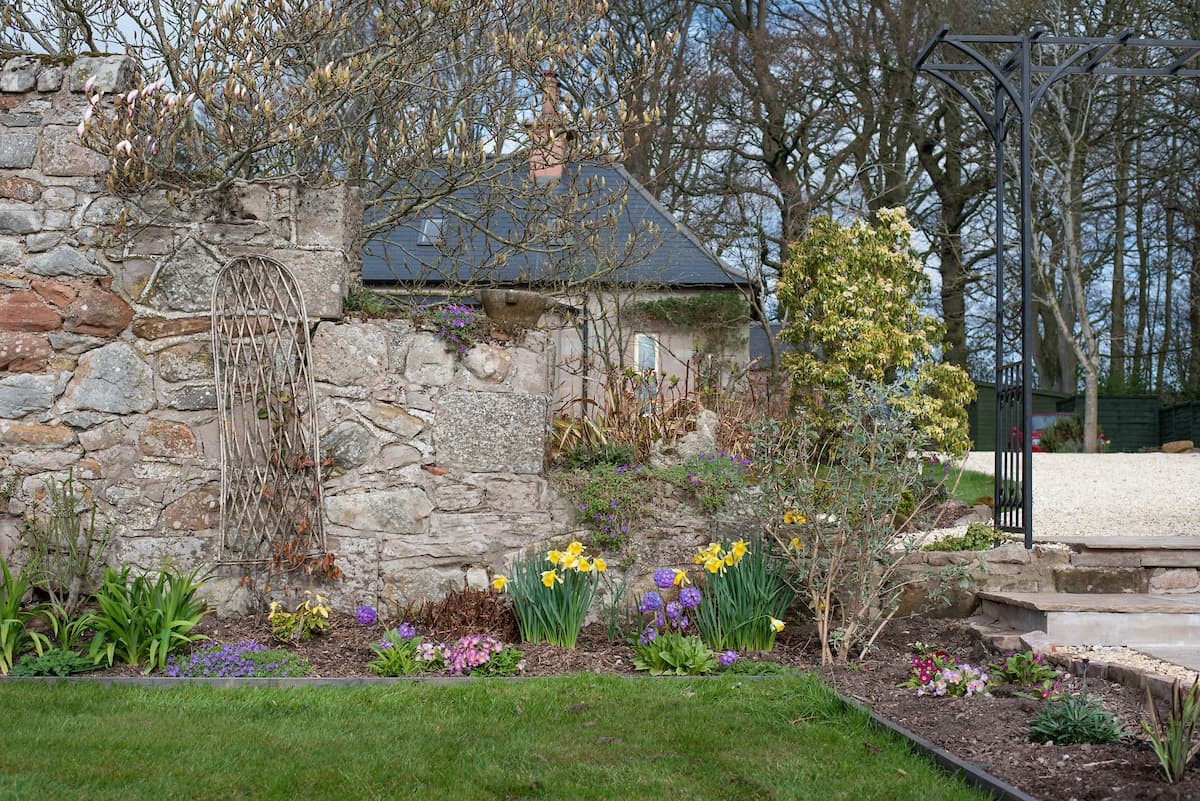 Hiddenhus - colourful border within the pretty walled garden