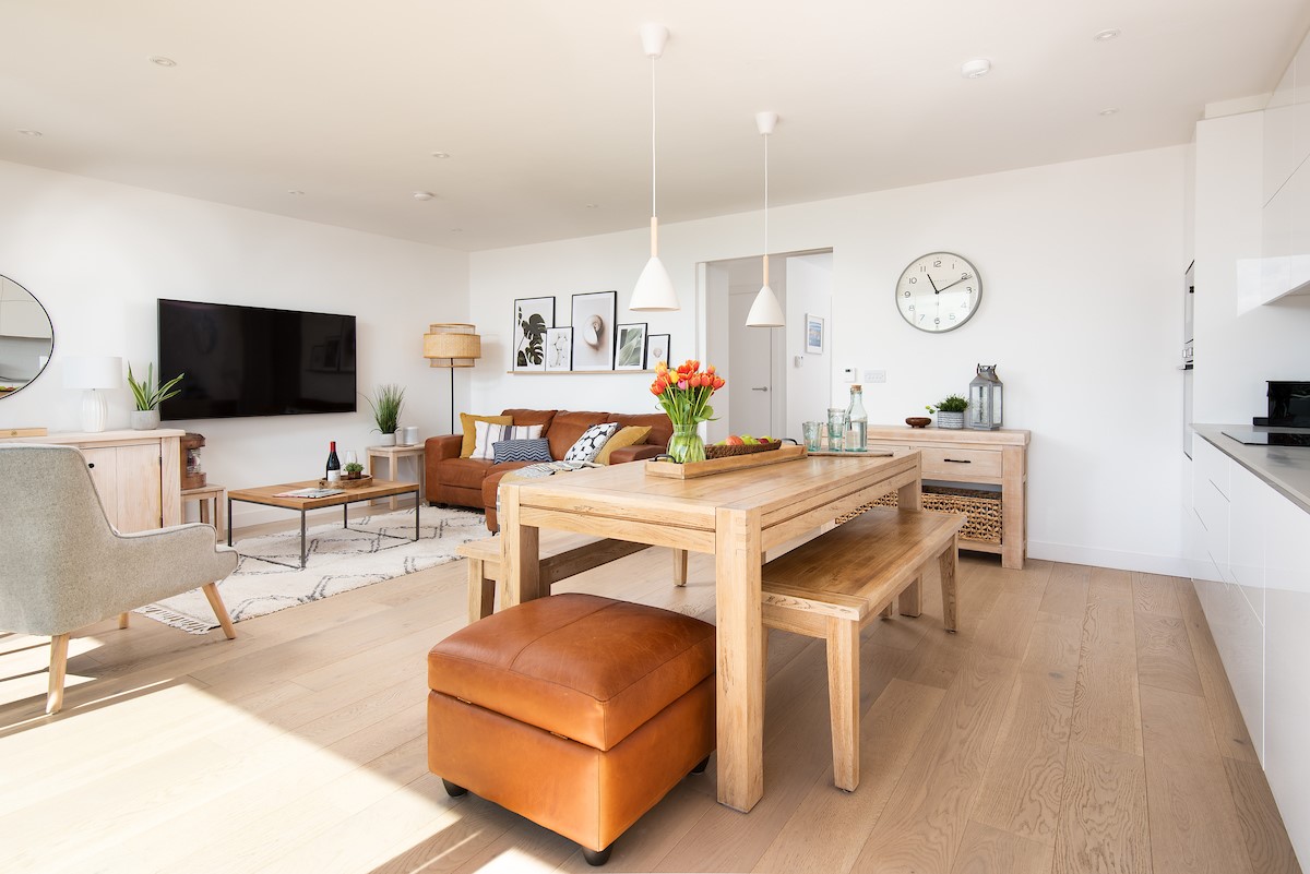 6 The Bay, Coldingham - modern pendant lighting is mounted above the chunky dining table and benches