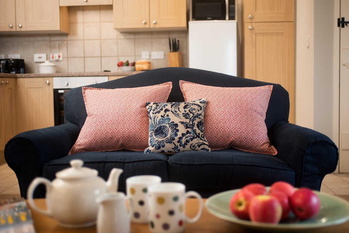 The Bothy at Cheswick - snuggle-worthy sofa for two in the open-plan living space