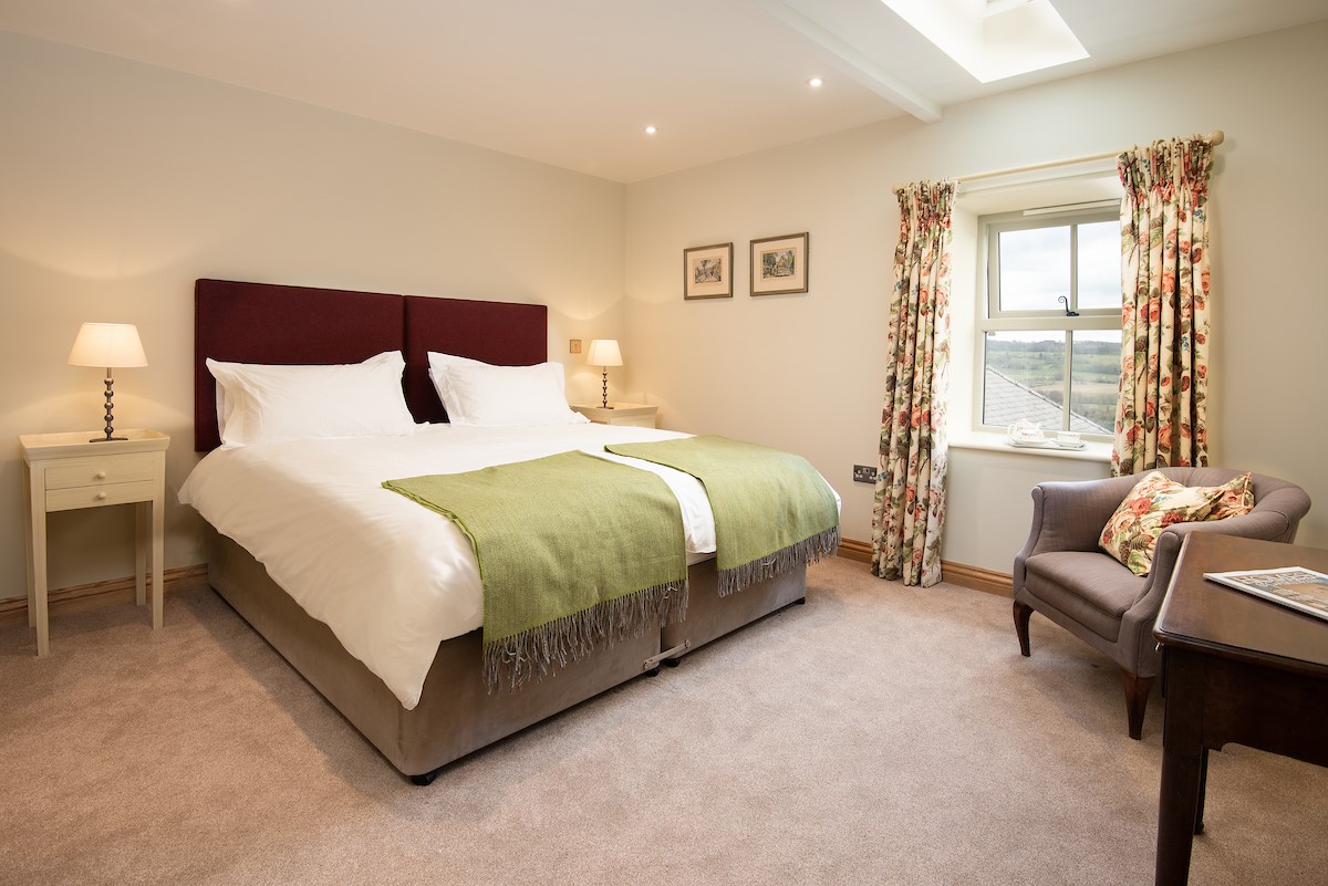 Old Granary House - bedroom one with zip and link beds, configured as a super king double or twin
