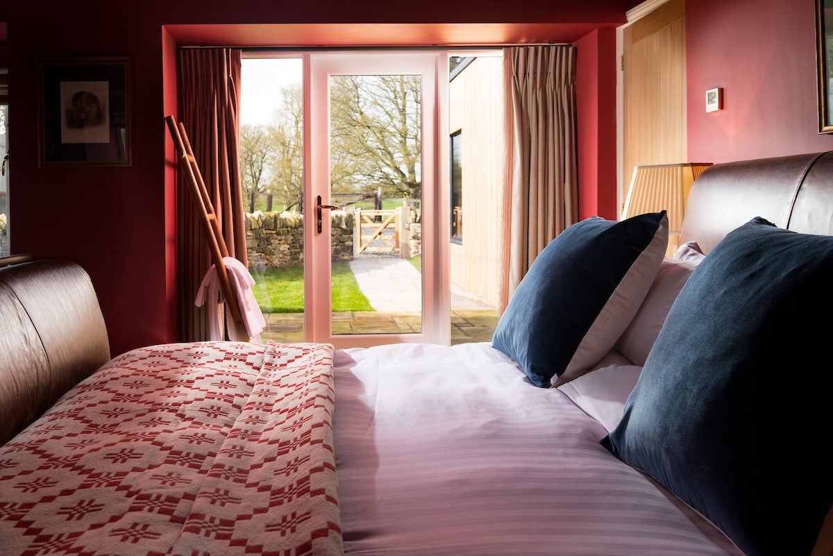 Lakeside Cottage - Edward - the glass door in the bedroom opens out to the enclosed garden