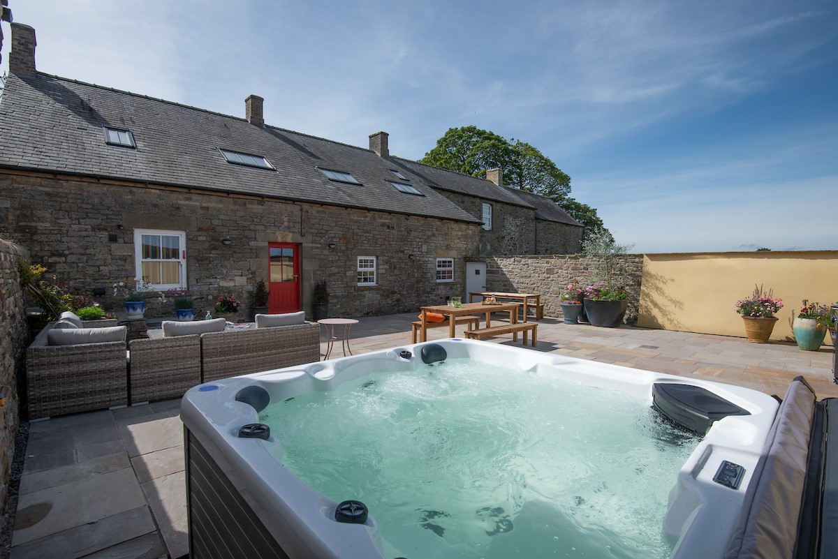 Fell End - hot tub in the sheltered courtyard to the rear of the property