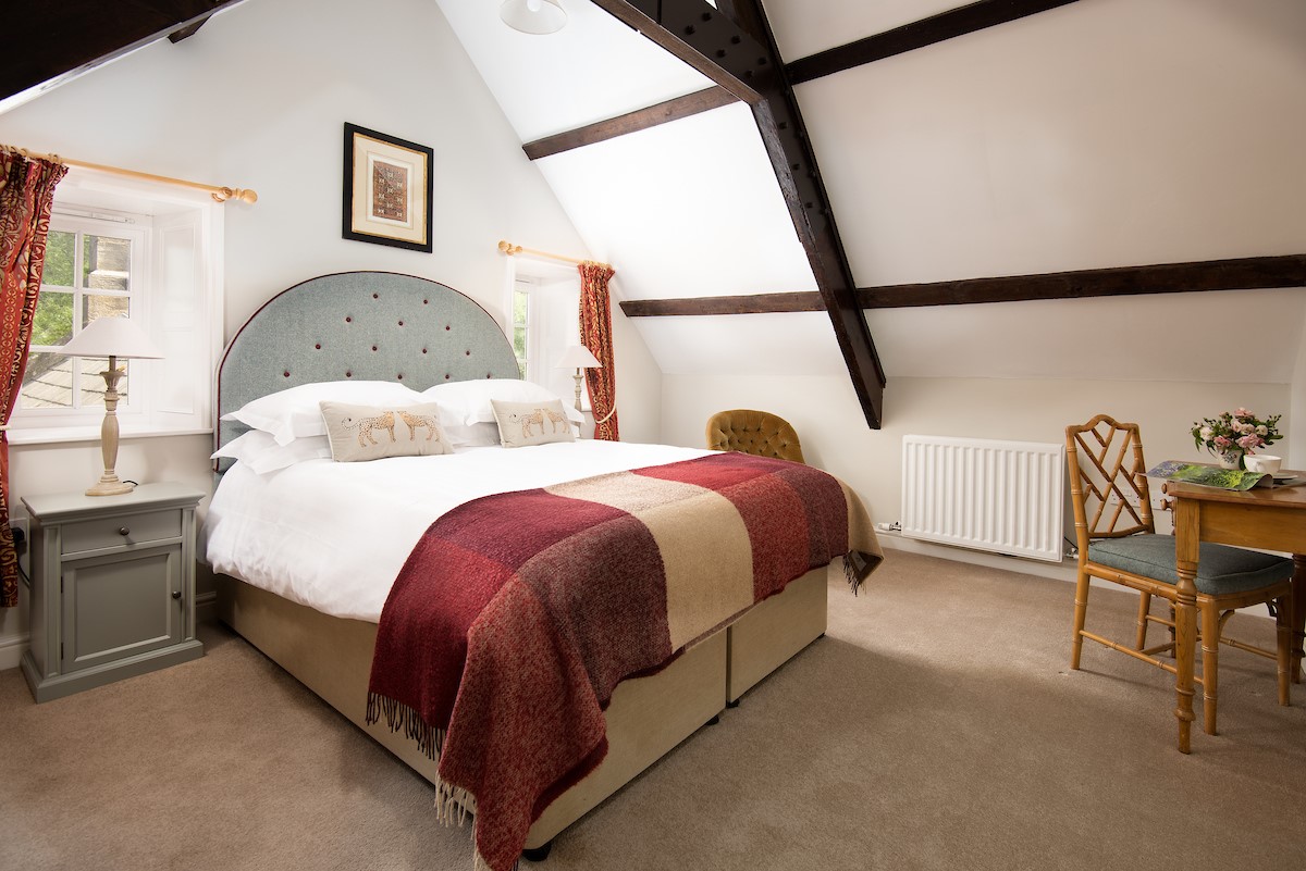 East End Cottage - bedroom one with King size bed and tweed headboard