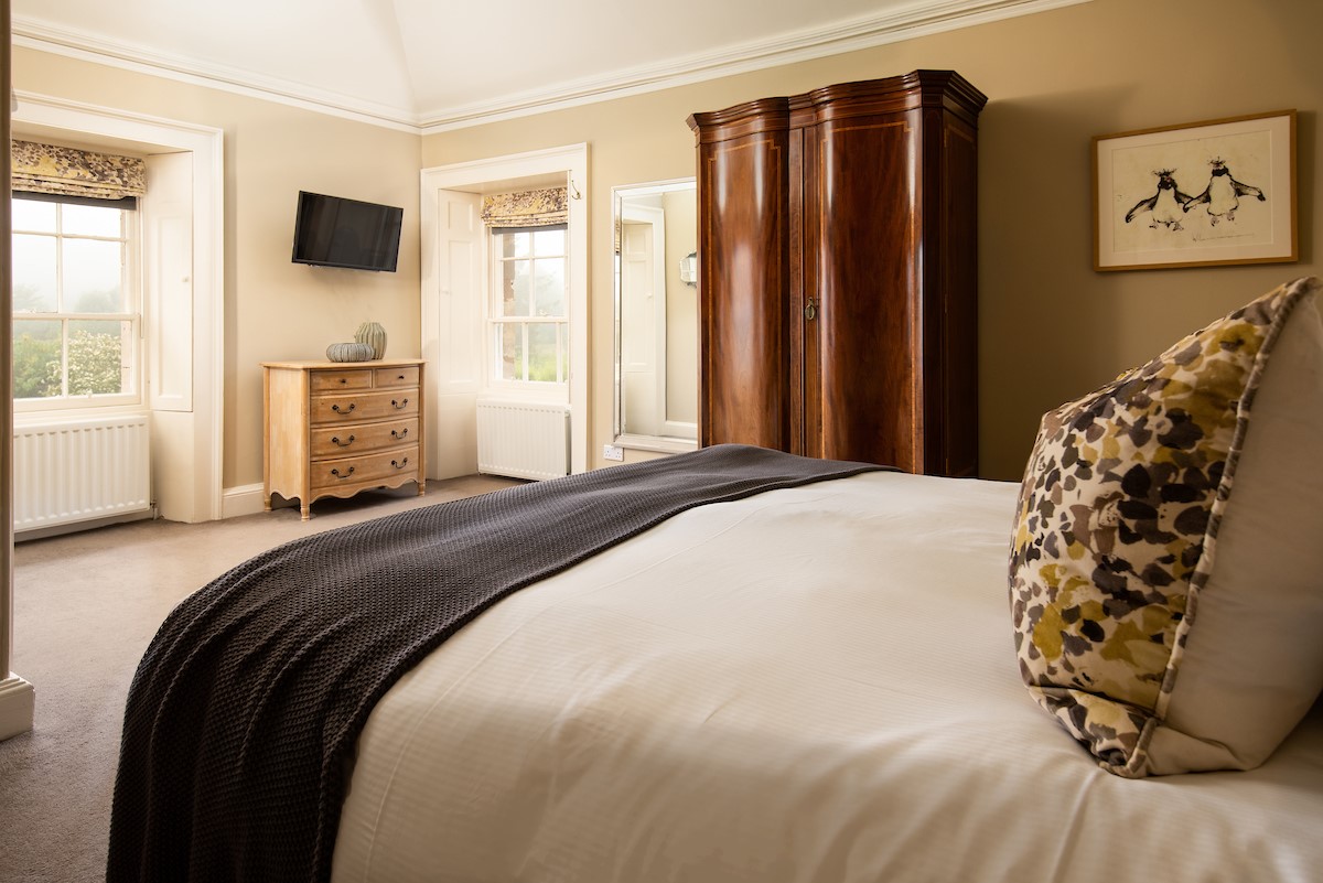 Seaview House - super king bed in bedroom two with chest of drawers and large wardrobe