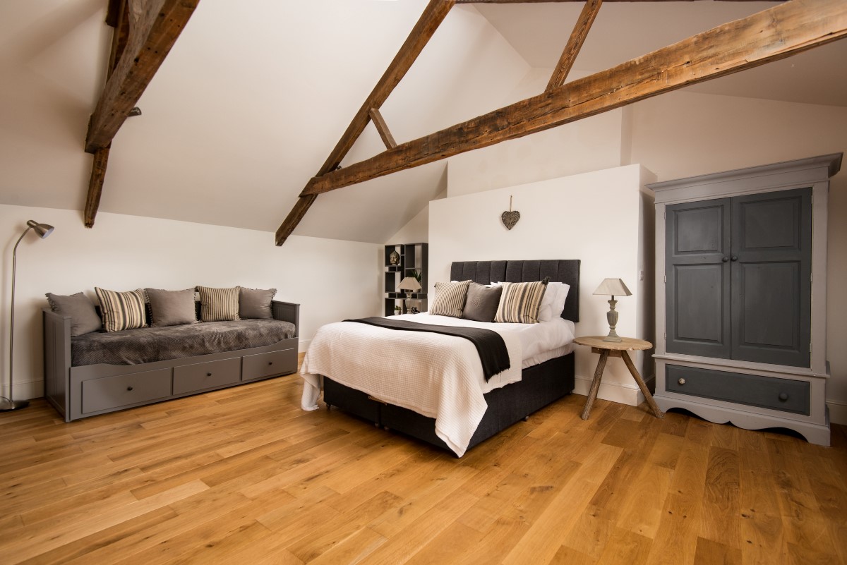 Number One Clayport Street - bedroom five on second floor with zip and link beds, wardrobe and sofa