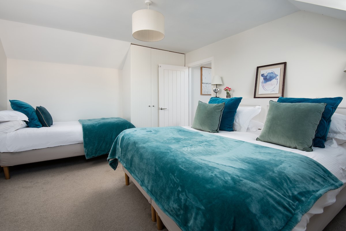 Duneside House - bedroom one with super king size bed and a single bed for flexible sleeping arrangements, ideal for use as a family room