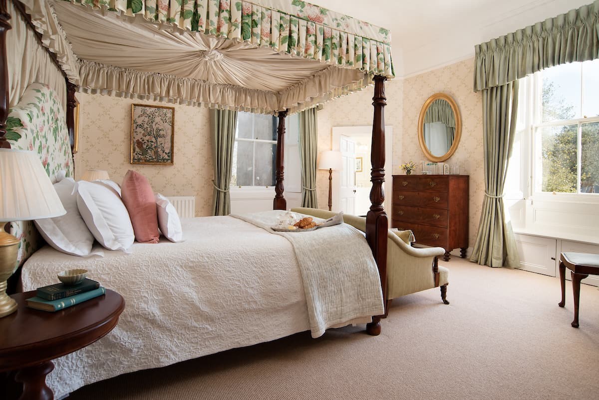 The Tower, Keith Marischal - bedroom one with four-poster canopy bed, antique mahogany furniture and window seat to admire the private grounds