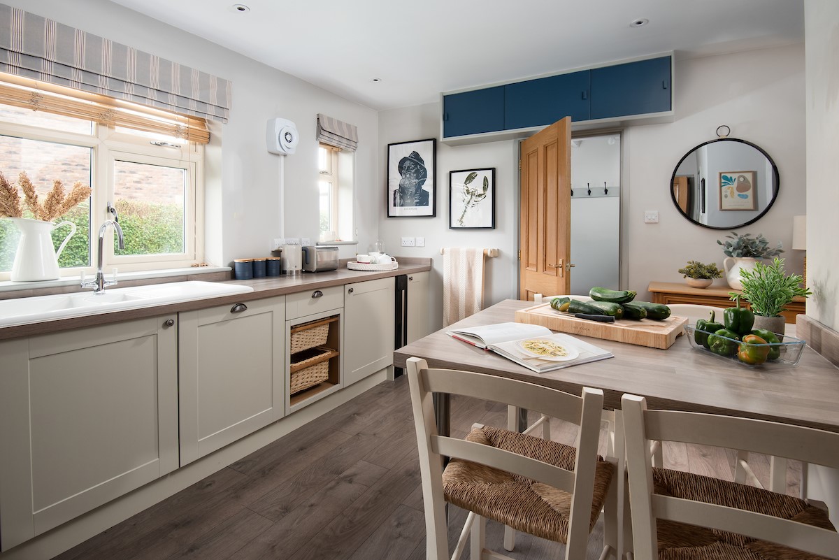 Greengate - kitchen with dining space for four guests and door leading to utility room