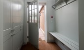 Hillside Cottage - entrance into boot room/utility area with handy bench seating and hanging hooks