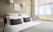 Marine House Cottage - bedroom one with comfortable king size bed and sea views