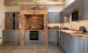 The Old Byre at West Moneylaws - the contemporary kitchen with wonderful wood and brick rustic touches
