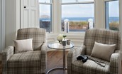 East Bay Beach House - large bay window in the sitting room with armchairs