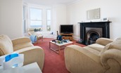 East Bay Beach House - TV room/play room with gas fire, TV, sofas and large bay window with sea views