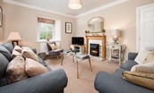 Berryburn Cottage - sitting room with sofas and electric fire
