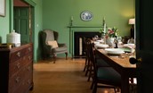 Cloister House - dining room with open fire, seating for eight guests and doors leading to the kitchen
