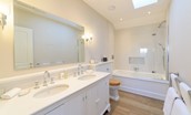 Fenton Lodge - North bedroom en suite bathroom with bath and shower over, double basins and WC