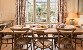 Broadgate House - kitchen dining table with seating for 10 guests and door leading to outside seating area