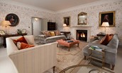Broadgate House - drawing room with large sofas and open fire