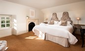 Garden House - bedroom one with twin beds, decorative fireplace, side tables and dressing table