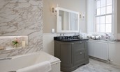 Glenburnie - bathroom with bath and shower over, basin and vanity unit