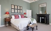 Glenburnie - bedroom with zip and link beds, decorative fireplace and side tables