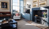 Glenburnie - living area with armchair, TV and original range