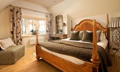 Captain's Landing - bedroom one with double bed, chair and plenty of storage space